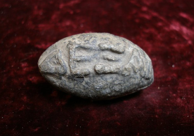 Sling bullet, photograph © Trustees of the British Museum via The British Museum (Athens; 4th c. BCE; lead)
